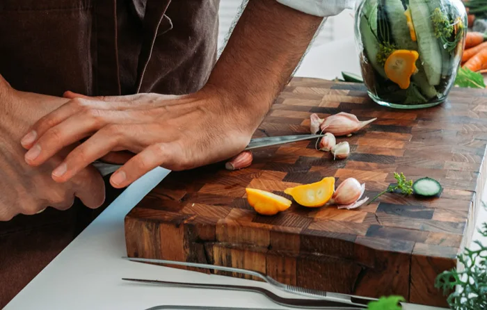 Man using an end grain cutting board