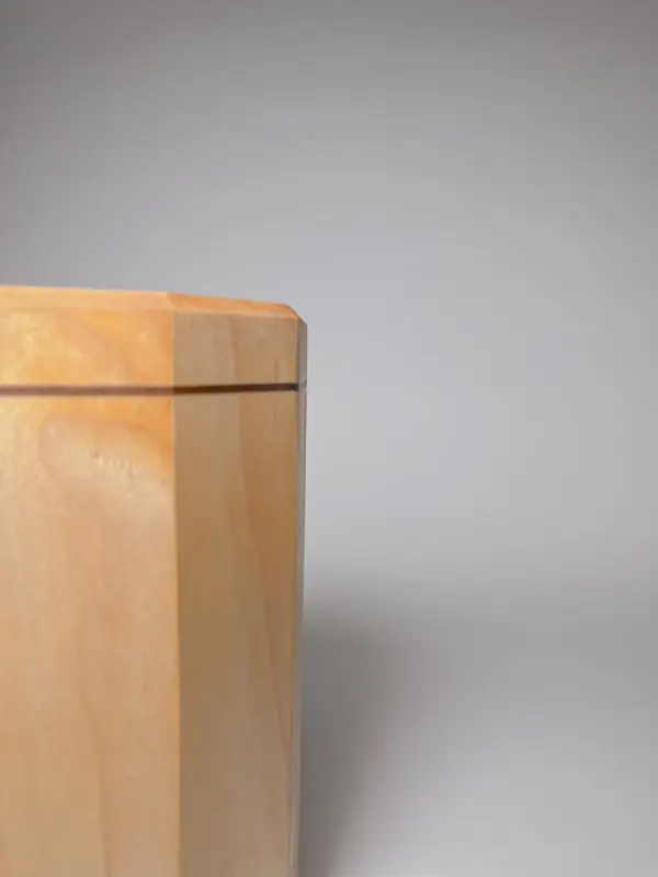Maple wood kitchen utensil holder with walnut strip close up view