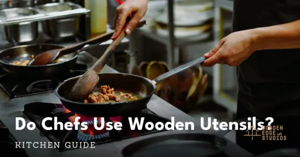 Professional chef stirring with a wooden spoon over a gas flame in a commercial kitchen
